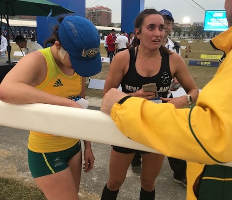 An exhausted Marina Carrier and New Zealand's Rebecca Jamieson after the Laser Run at the 2019 Asia/Oceania Championships in Wuhan, China.